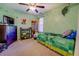 This bedroom features a green color scheme, wooden dresser and a playful ceiling fan at 265 Oak Hill Dr, Covington, GA 30016
