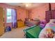 Bright bedroom featuring whimsical decor, a comfy bed, and a sunlit window at 265 Oak Hill Dr, Covington, GA 30016