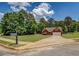 Charming red brick home featuring a well-manicured lawn and mature trees at 265 Oak Hill Dr, Covington, GA 30016
