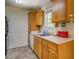 Well-lit kitchen features wood cabinets, neutral countertops, and modern sink fixtures at 265 Oak Hill Dr, Covington, GA 30016