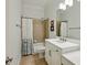 Cozy bathroom features a shower-tub combo with tan tiling, a white vanity and neutral decor at 3687 Canyon Ridge Ne Ct, Brookhaven, GA 30319