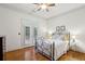 Bright bedroom featuring hardwood floors, neutral walls, and access to a private balcony through double doors at 3687 Canyon Ridge Ne Ct, Brookhaven, GA 30319
