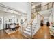 Bright foyer with hardwood floors, staircase, and an open view of the dining and living areas at 3687 Canyon Ridge Ne Ct, Brookhaven, GA 30319