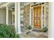 Elegant front entrance with a wooden door, stone accents, and a beautifully tiled porch at 3687 Canyon Ridge Ne Ct, Brookhaven, GA 30319