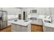 Modern white kitchen featuring stainless steel appliances, island, and ample cabinet space at 3687 Canyon Ridge Ne Ct, Brookhaven, GA 30319