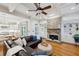 Elegant living room features a stone fireplace, coffered ceiling, and an open layout with hardwood floors at 3687 Canyon Ridge Ne Ct, Brookhaven, GA 30319