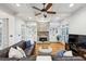 Cozy living room featuring a stone fireplace, built-in bookshelves, and hardwood flooring at 3687 Canyon Ridge Ne Ct, Brookhaven, GA 30319