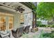 Inviting outdoor patio with ceiling fan, stone flooring, and wicker furniture for comfortable relaxation at 3687 Canyon Ridge Ne Ct, Brookhaven, GA 30319