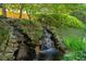 Picturesque waterfall feature in a beautifully landscaped backyard, adding a touch of serenity at 3687 Canyon Ridge Ne Ct, Brookhaven, GA 30319