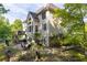Beautifully landscaped backyard with a spacious stone patio, surrounded by mature trees at 3705 Rolling Creek Dr, Buford, GA 30519