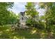 The property boasts an expansive, tree-lined backyard with a patio and terraced garden at 3705 Rolling Creek Dr, Buford, GA 30519