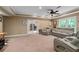 Finished basement featuring plush seating, neutral paint, and french doors to an office at 3705 Rolling Creek Dr, Buford, GA 30519