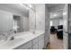 Bright bathroom featuring double sinks, tile floors, and a view into the next room at 3705 Rolling Creek Dr, Buford, GA 30519