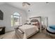 Well-lit bedroom featuring neutral walls, carpet, large window, bed, and a leaning mirror at 3705 Rolling Creek Dr, Buford, GA 30519