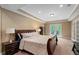 Spacious bedroom with french doors and a large bed with wood headboard, plus natural light at 3705 Rolling Creek Dr, Buford, GA 30519