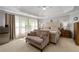 Bright bedroom showcasing a tufted headboard, neutral colors, and an abundance of natural light at 3705 Rolling Creek Dr, Buford, GA 30519