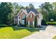 Charming two-story brick home with driveway, basketball hoop and beautifully landscaped front yard at 3705 Rolling Creek Dr, Buford, GA 30519