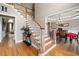 Grand foyer with hardwood floors, staircase and views into the dining and living room at 3705 Rolling Creek Dr, Buford, GA 30519