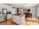 Bright kitchen with stainless steel appliances, white cabinets, and a functional center island with cooktop at 3705 Rolling Creek Dr, Buford, GA 30519