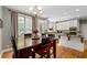 Kitchen with breakfast nook, white cabinets, and hardwood floors at 3705 Rolling Creek Dr, Buford, GA 30519