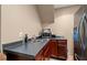 Basement kitchenette equipped with stainless steel appliances and dark wood cabinets at 3705 Rolling Creek Dr, Buford, GA 30519