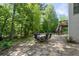Spacious stone patio offers ample space for outdoor entertaining amidst a serene, wooded setting at 3705 Rolling Creek Dr, Buford, GA 30519