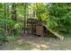 Rustic backyard playground featuring a swing set, slide, and play structure at 3705 Rolling Creek Dr, Buford, GA 30519