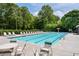 Community swimming pool with lounge chairs and umbrellas, ideal for summer relaxation at 3705 Rolling Creek Dr, Buford, GA 30519