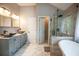 Bright bathroom with double vanity, vessel sinks, soaking tub and walk-in shower at 4271 Haywater Cv, Buford, GA 30519