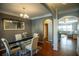 Elegant dining room featuring hardwood floors and decorative mirror, seamlessly connecting to the adjacent living space at 4271 Haywater Cv, Buford, GA 30519