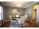Elegant dining room with a glass-top table, stylish chairs, and a decorative mirror, perfect for entertaining guests at 4271 Haywater Cv, Buford, GA 30519