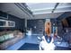 Finished garage with epoxy floors, comfortable seating area, and space for hobbies or storage at 4271 Haywater Cv, Buford, GA 30519