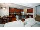 Bright, modern kitchen with stainless steel appliances, granite countertops, and island seating overlooking the living area at 4271 Haywater Cv, Buford, GA 30519