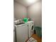 Well-lit laundry room with washer, dryer, and storage for supplies at 4271 Haywater Cv, Buford, GA 30519