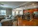 Open-concept living area with modern kitchen, stainless steel appliances, and a comfortable sectional sofa at 4271 Haywater Cv, Buford, GA 30519