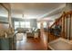 Spacious living room with hardwood floors, a comfortable sectional sofa, and an open view to the dining area at 4271 Haywater Cv, Buford, GA 30519