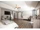 Bright and airy main bedroom with ample floor space, tray ceiling, ceiling fan, a large window, and modern decor at 4271 Haywater Cv, Buford, GA 30519