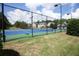 Community tennis court is surrounded by a fence and landscaping at 4271 Haywater Cv, Buford, GA 30519