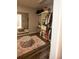 Spacious walk-in closet featuring a large mirror, shelving units and a storage ottoman at 4271 Haywater Cv, Buford, GA 30519