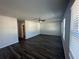 Living room featuring ceiling fan, grey walls, dark wood-look flooring and natural light at 8664 Webb Rd, Riverdale, GA 30274