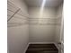 Walk-in closet with wire shelving and wood-look flooring at 8664 Webb Rd, Riverdale, GA 30274