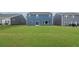 Spacious backyard with lush green lawn bordered by neighboring homes and tall trees at 107 Cherry Glen Way, Euharlee, GA 30145