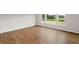 Bedroom with hardwood floors and large windows, offering natural light and outdoor views at 107 Cherry Glen Way, Euharlee, GA 30145