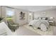 Cozy bedroom with neutral tones, large windows, and a comfortable seating area at 107 Cherry Glen Way, Euharlee, GA 30145