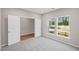 Bedroom with carpet flooring, a view of the outdoors and double doors at 107 Cherry Glen Way, Euharlee, GA 30145