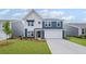 Charming two-story home featuring a blue and white exterior with a manicured lawn at 107 Cherry Glen Way, Euharlee, GA 30145