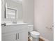 Clean half-bathroom featuring a white vanity with modern fixtures and a matching toilet at 107 Cherry Glen Way, Euharlee, GA 30145