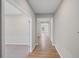 Hallway with hardwood flooring and neutral walls leading to various rooms at 107 Cherry Glen Way, Euharlee, GA 30145