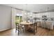 Bright kitchen and breakfast area featuring white cabinets, granite countertops, and hardwood floors at 107 Cherry Glen Way, Euharlee, GA 30145