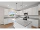 Bright kitchen with white cabinets, granite countertops, and stainless steel appliances at 107 Cherry Glen Way, Euharlee, GA 30145